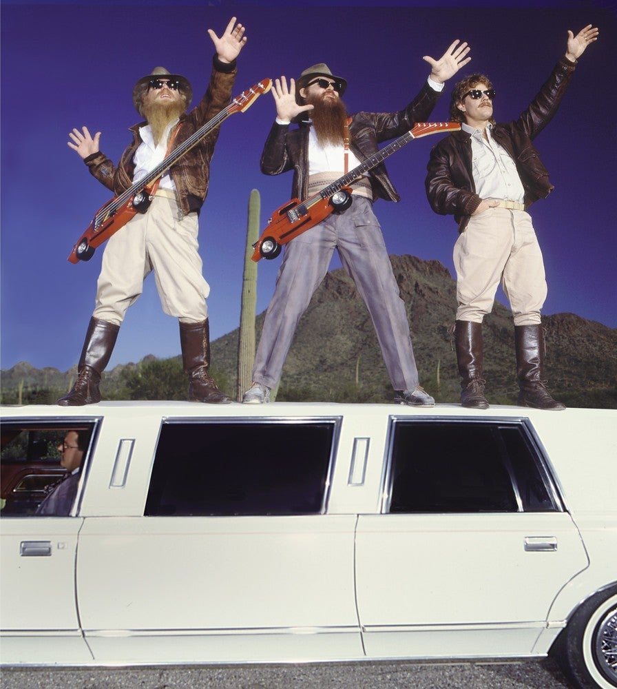 ZZ Top riding on top of a limousine